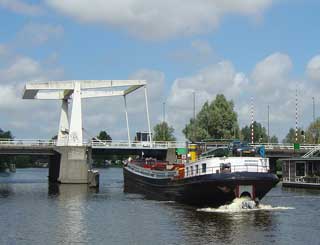 An impatient barge can hardly wait for the bridge to open