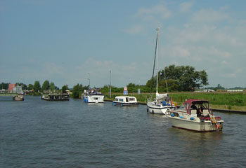 Boats file through the Workum rail bridge after the lunch time break