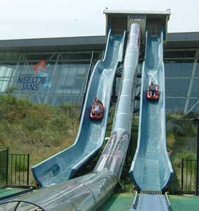 Tim & Lou take an easy lead over John in the waterslide race (Photo by Chris Turner)