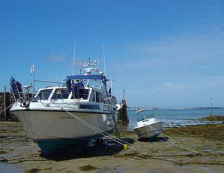 Safely grounded in Herm harbour, a little more level than some